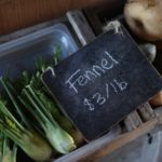 A chalkboard sign prices fennel at Tierra Vegetables.