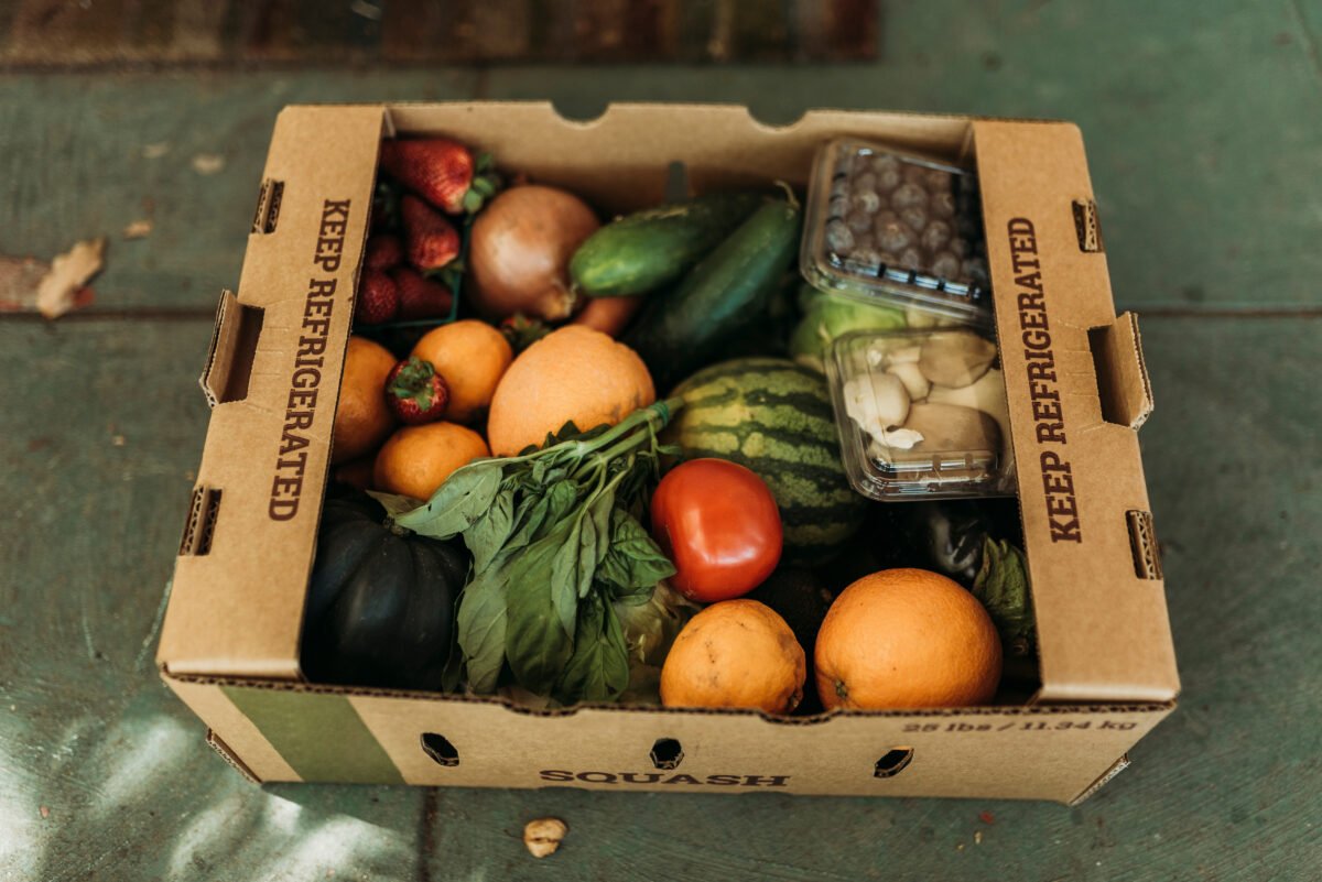 Cardboard box filled with fruits and vegetables