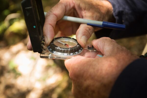 Hand holding a compass