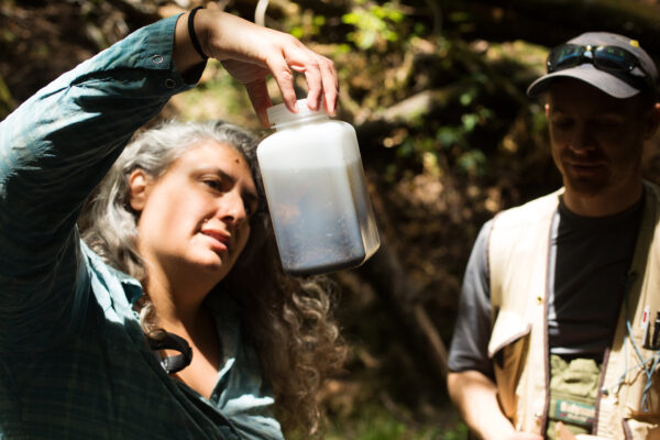 a woman inspecting a water sample