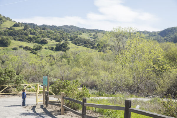 Entrance to park with green hillside in the background.