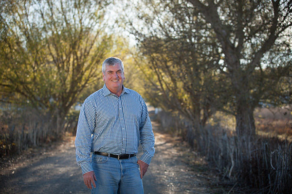 Supervisor David Rabbitt standing on a path lined by trees. 