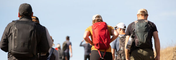 backs of a group of people on a hike