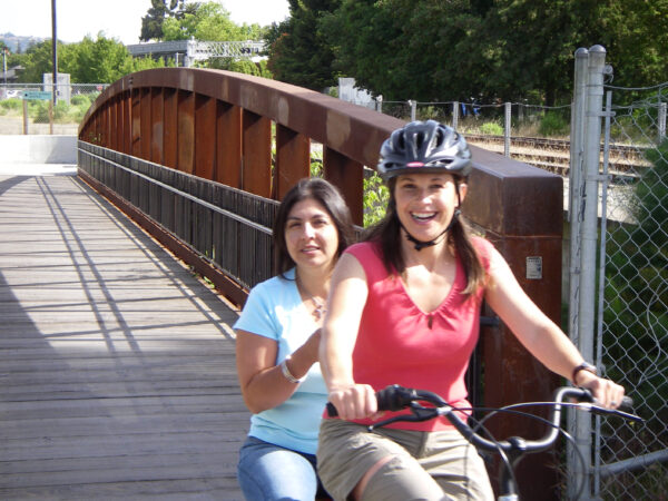 Misti and another woman riding a bike