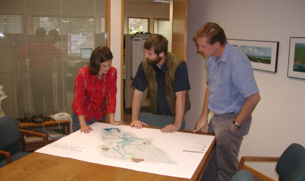 Misti and colleagues talking around a table