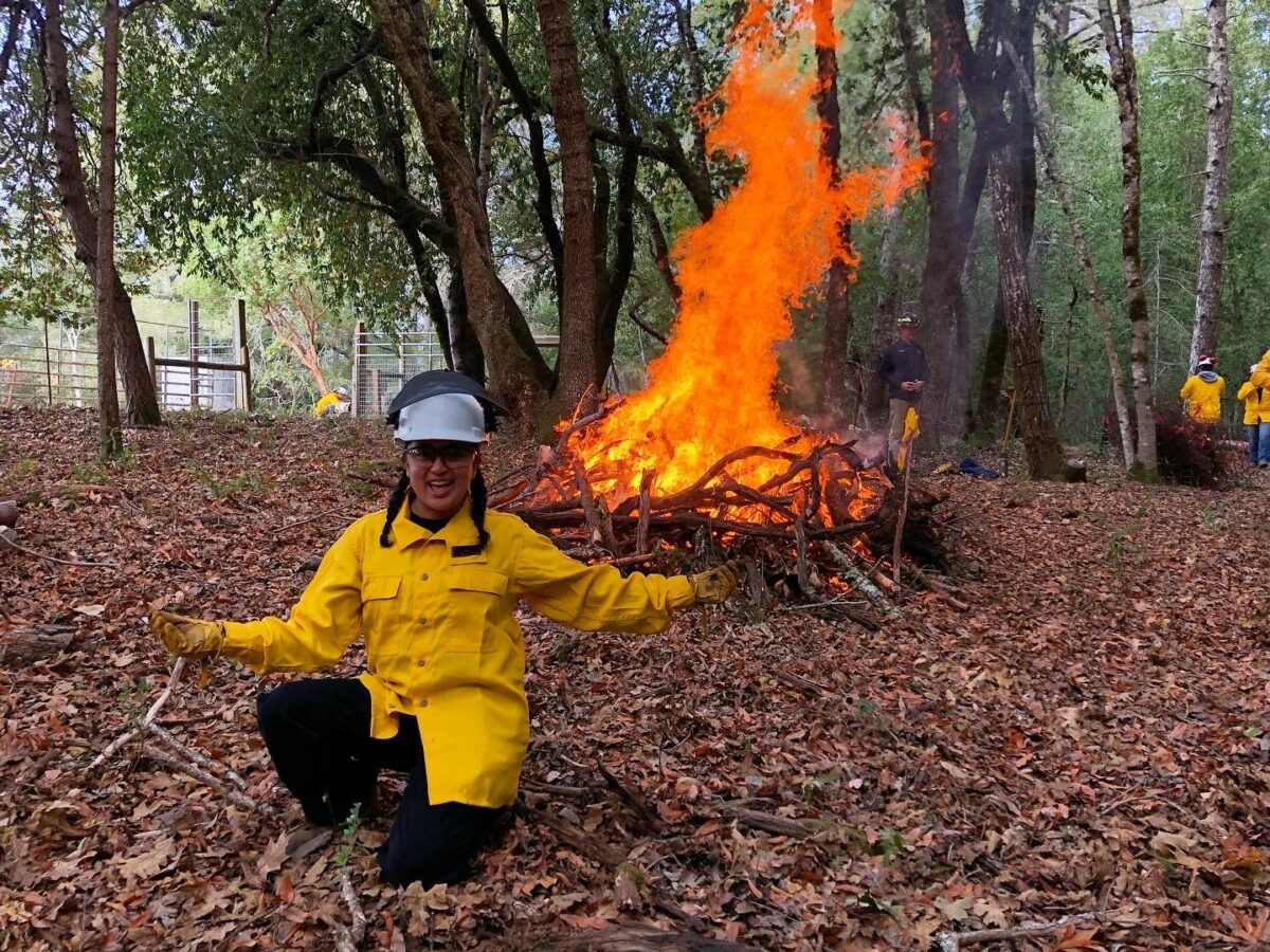 woman standing in front of fire