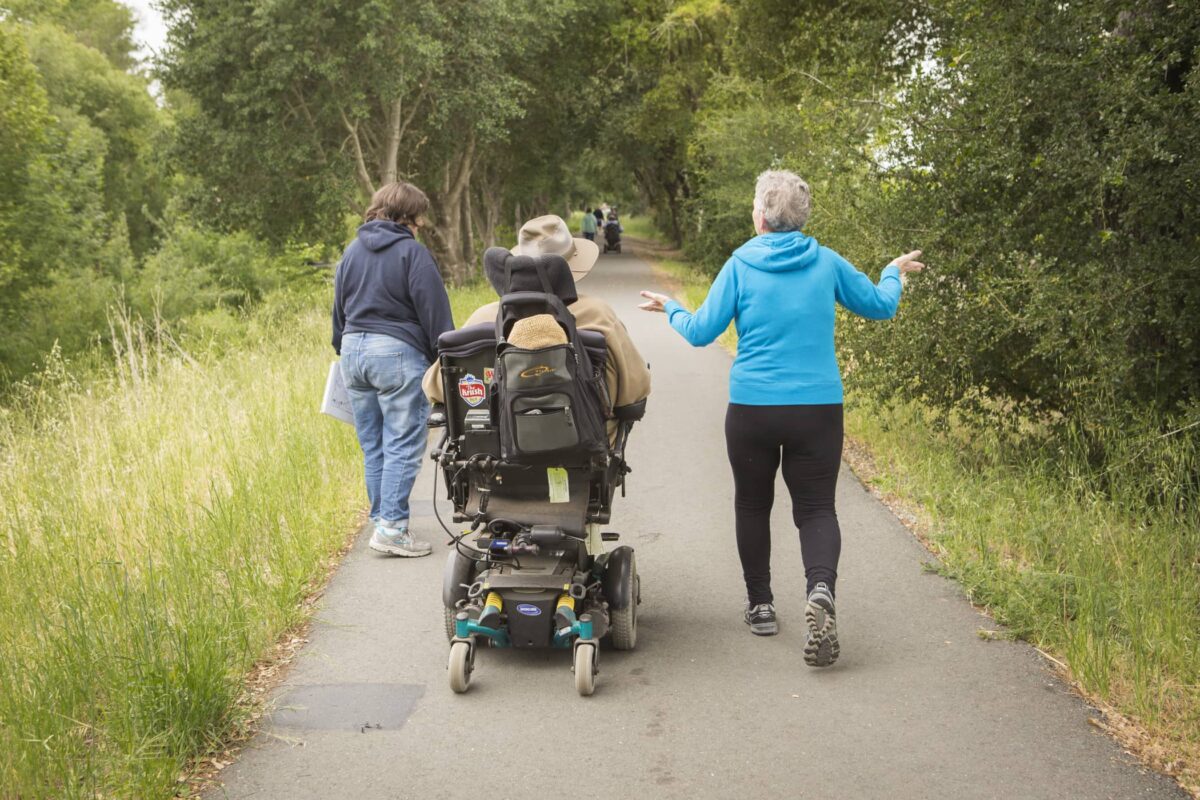 a person in a wheelchair and a person and a walk