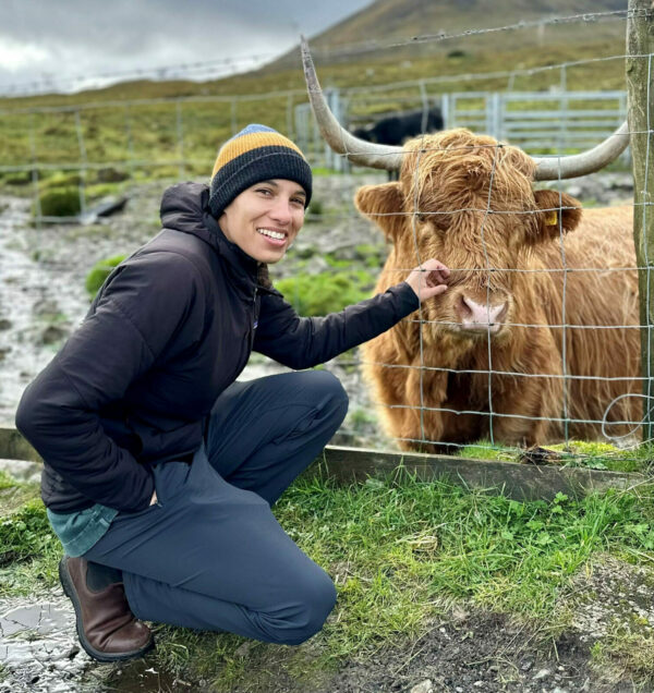 woman smiling with a cow