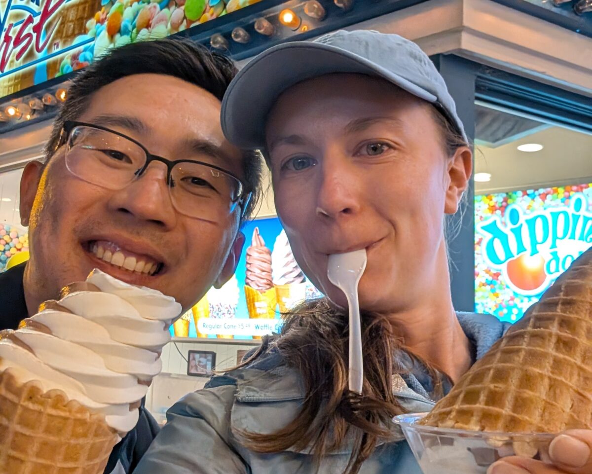 Mary Chambers, our Agricultural Specialist, and her husband smiling at the camera while eating ice cream cones.
